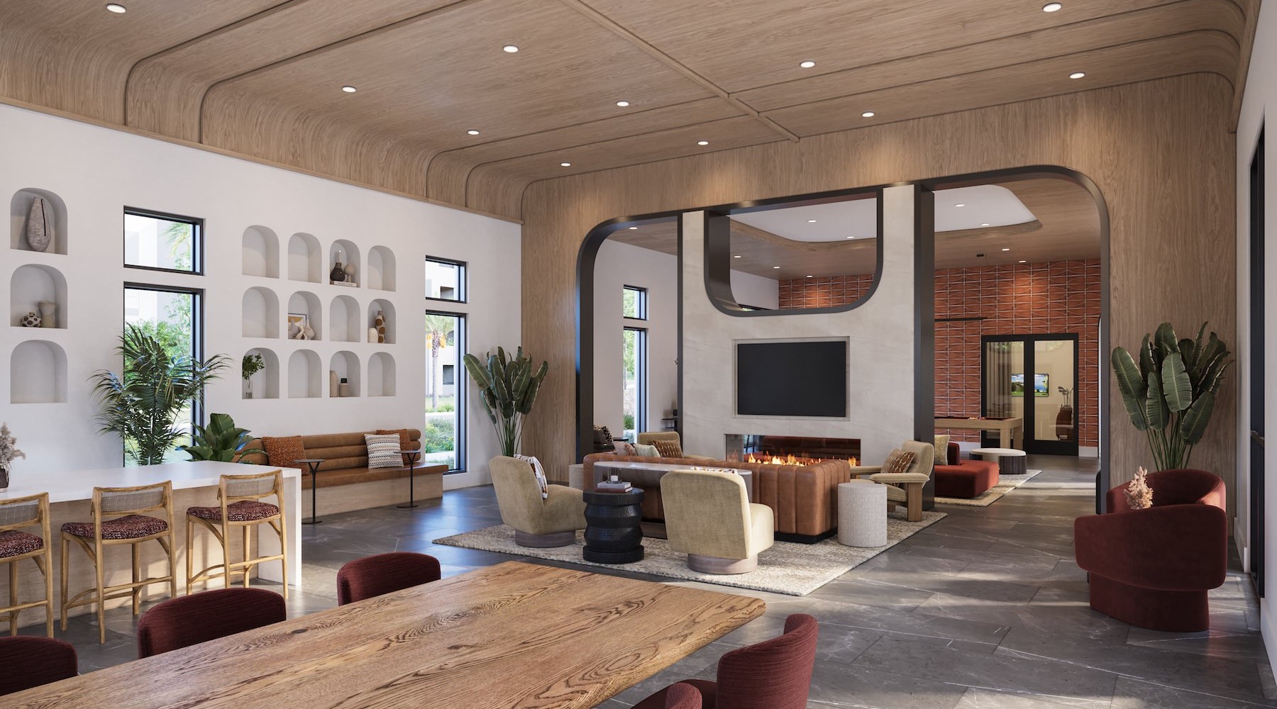 a clubroom with tables, chairs, couches and a fireplace