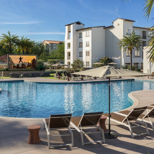 a swimming pool with lounge chairs