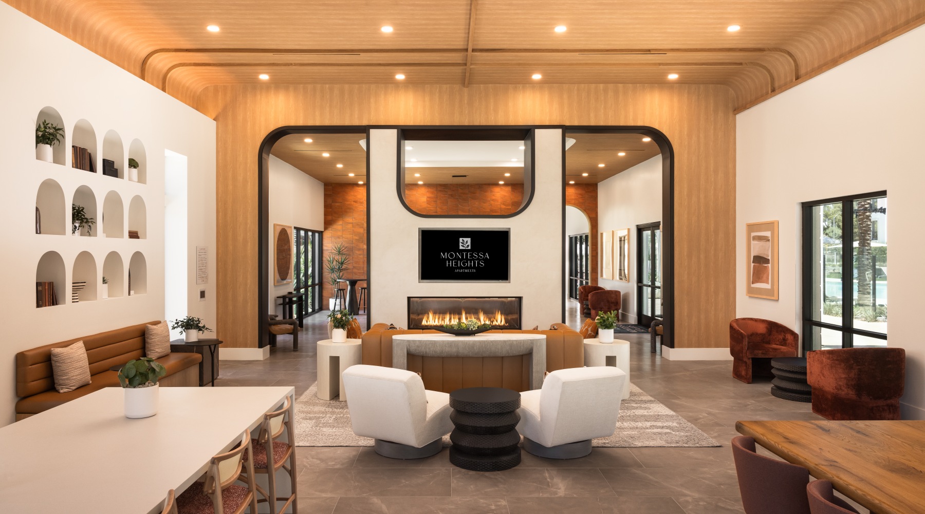 Modern clubroom with tables, chairs, fireplace and tv at Montessa Heights in Murrieta