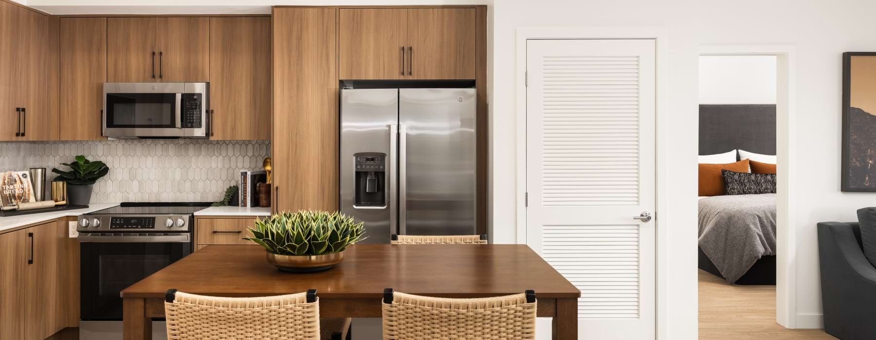 Modern Kitchen with dark cabinets at tile backsplash at Montessa Heights apartments in Murrieta, CA