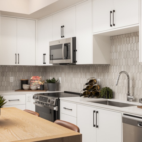 Kitchen with white cabinets in new apartments in Murrieta, CA at Montessa Heights.