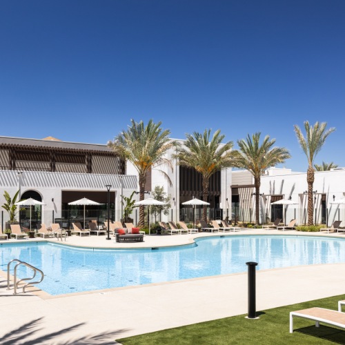a swimming pool with lounge chairs