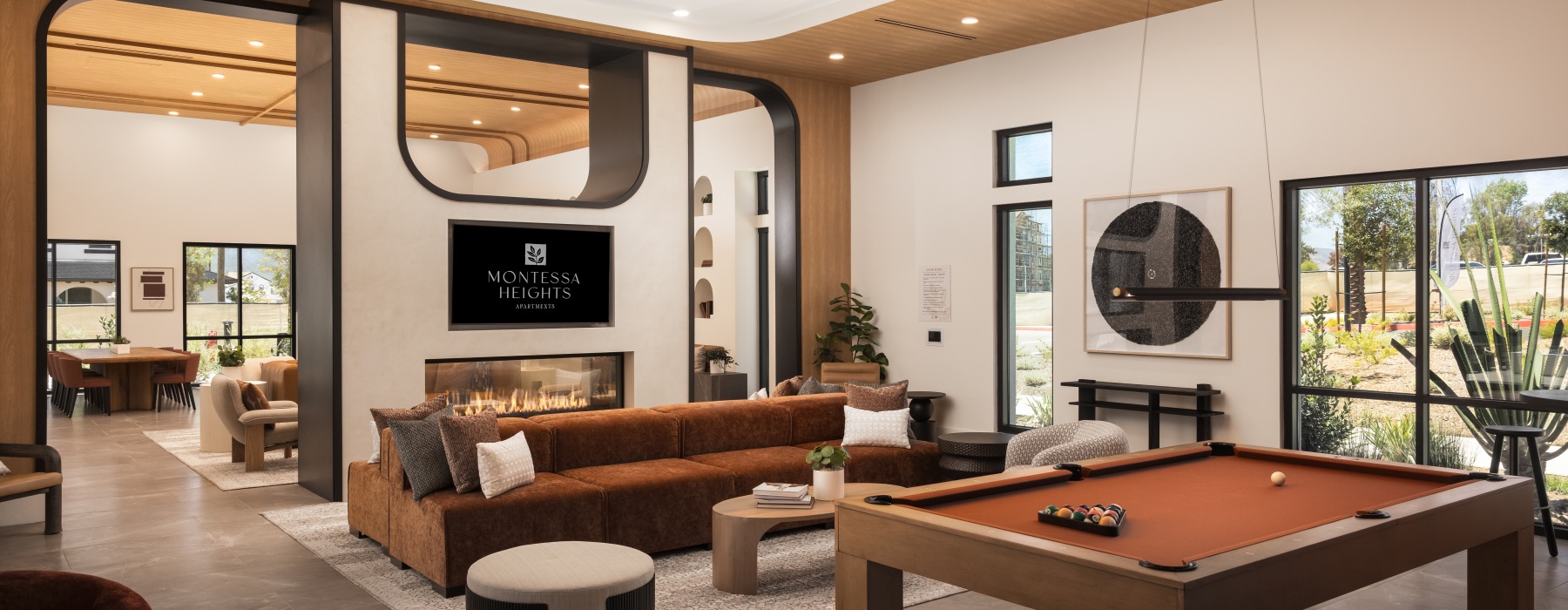 Clubroom with billiards, couch, tv and fireplace at Montessa Heights, apartments in Murrieta, CA
