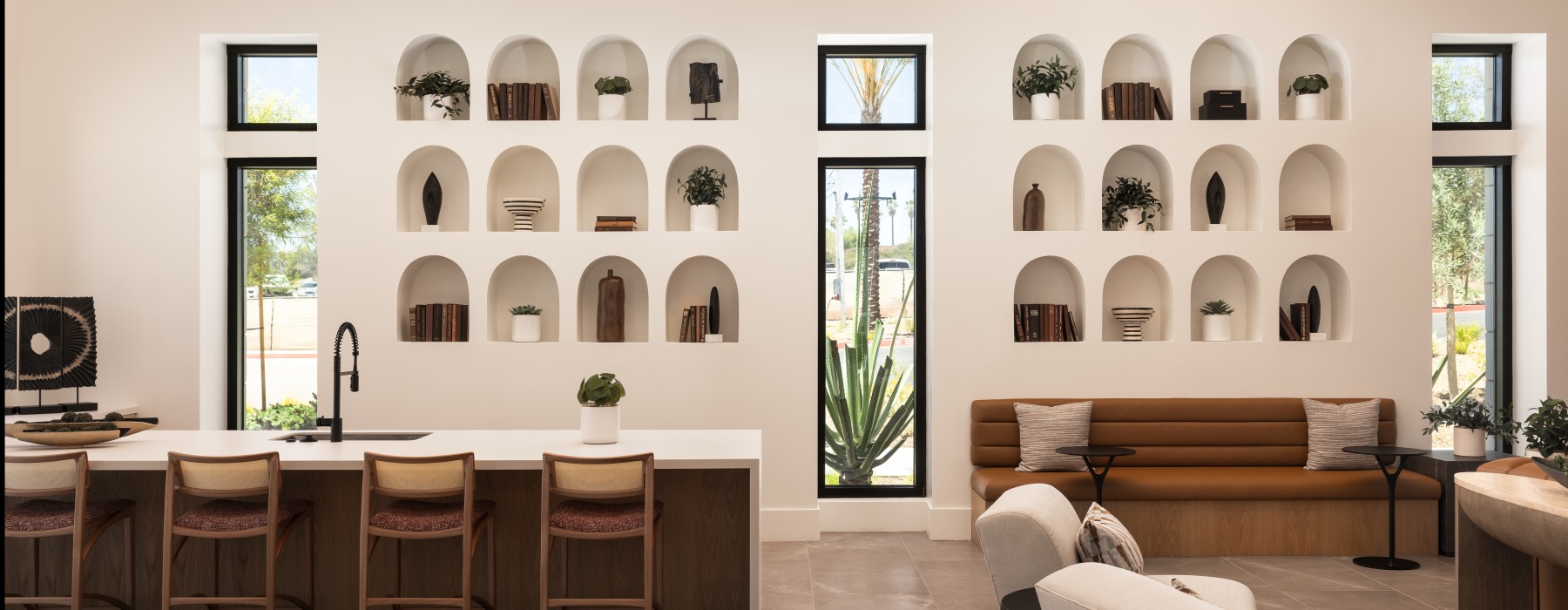 Modern resident clubhouse at Montessa Heights apartments with custom architectural shelving and contemporary seating